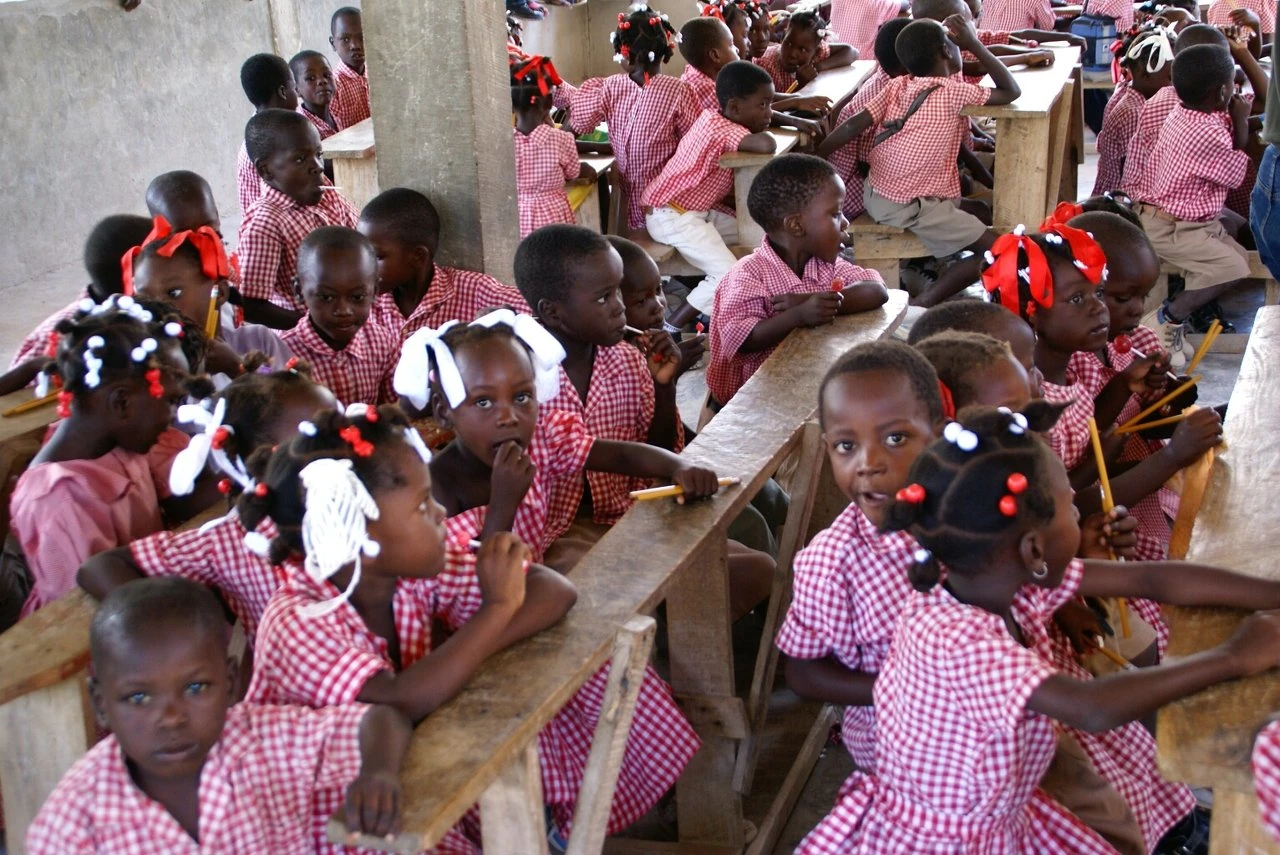 Children seated together at school, pictured on the organization’s original website