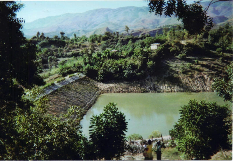 A pond and green hills pictured in the organization’s community project collection